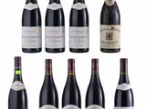 a group of bottles of red wine sitting next to each other