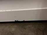 a close up of a door handle on a white refrigerator