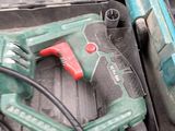 a corded drill and a corded hammer in a box