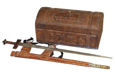an old wooden chest with two swords and a wooden box