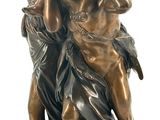 bronze statue of a woman holding a child on a pedestal