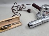 un petit objet en argent et une boîte en bois contenant un stylo