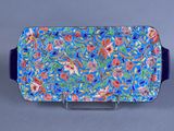 blue and red serving tray with flowers and leaves on it