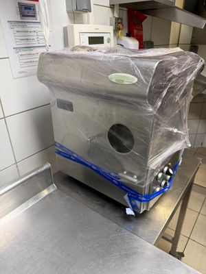 a machine that is wrapped in plastic in a kitchen