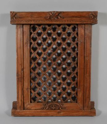 an old wooden window with a lattice design on it