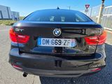 a black bmw car parked on the side of the road