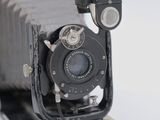 an old camera sitting on top of a white table