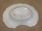a white bowl with a brown rim on a table