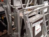 many metal ladders stacked on top of each other in a warehouse