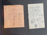 two drawings on a piece of paper hanging on a wall