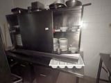 a black cabinet with pots and pans on top of it