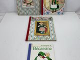 three children ' s books are lined up on a white surface