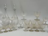 a lot of wine glasses and a decanter on the table