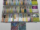 a lot of pokemon cards that are on the table