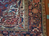 an oriental rug on a tiled floor with blue and red squares