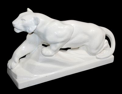 a white statue of a lion on a black background