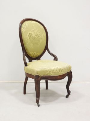 a chair that has a yellow upholstered seat on it