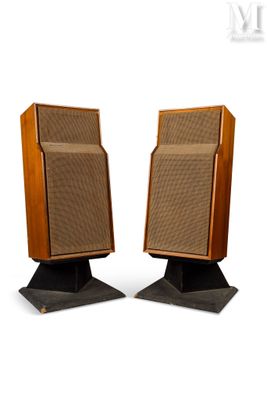 pair of vintage speakers on pedestals against a white background