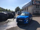 a blue car that is parked in front of a building