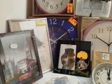 many different clocks and pictures on the table