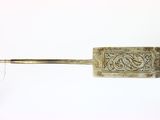 a metal object with a handle that has a design on it