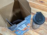 a cardboard box with a coffee cup inside of it on a table