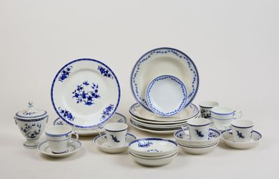 a lot of blue and white dishes and cups