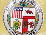 a picture of a city of los angeles seal on a yellow wall