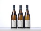 three bottles of wine sitting on top of a table next to each other