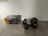 a black and yellow blow dryer sitting on the floor next to a black and yellow box