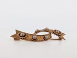 a close up of a hair clip with pearls on it
