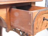 a wooden desk with a drawer on top of it