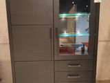 a cabinet with a glass door and drawers in it