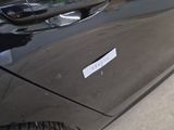 a sticker on the door of a black car