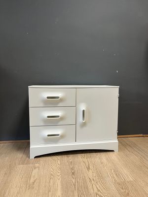 an image of a white dresser with three drawers on top of it