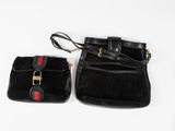 two black purses with red and white stripes on them