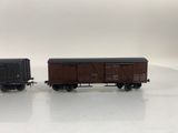 two toy train cars sitting side by side on a white surface