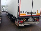 two trucks that are parked next to each other