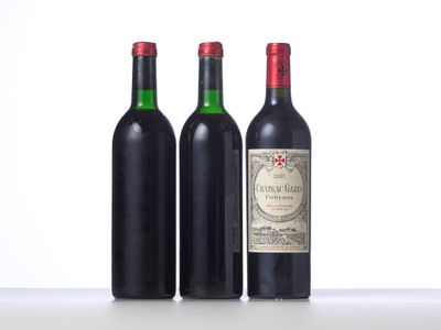 three bottles of wine are lined up on a table