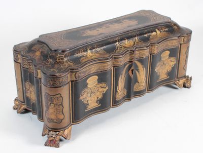 a black and gold chest sitting on a white surface