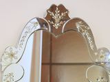 a mirror with a heart shaped frame on the wall