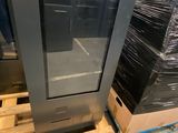 a television that is sitting on a pallet in a warehouse