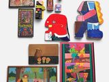 many pieces of art on display on the wall