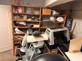 a lot of clutter in this room with a microwave and a microwave oven