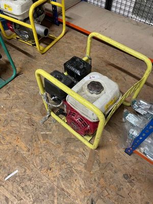 two portable generators sitting on the floor in the garage