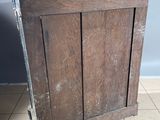 an old wooden cabinet with a door on the floor