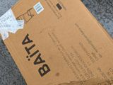 a box that is sitting on the ground with a sticker on it
