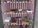 purple and white striped wallpapered room with open door and shelves