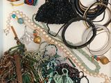 a white box filled with assorted bracelets and bracelets