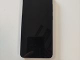 an image of a black cell phone sitting on top of a white table
